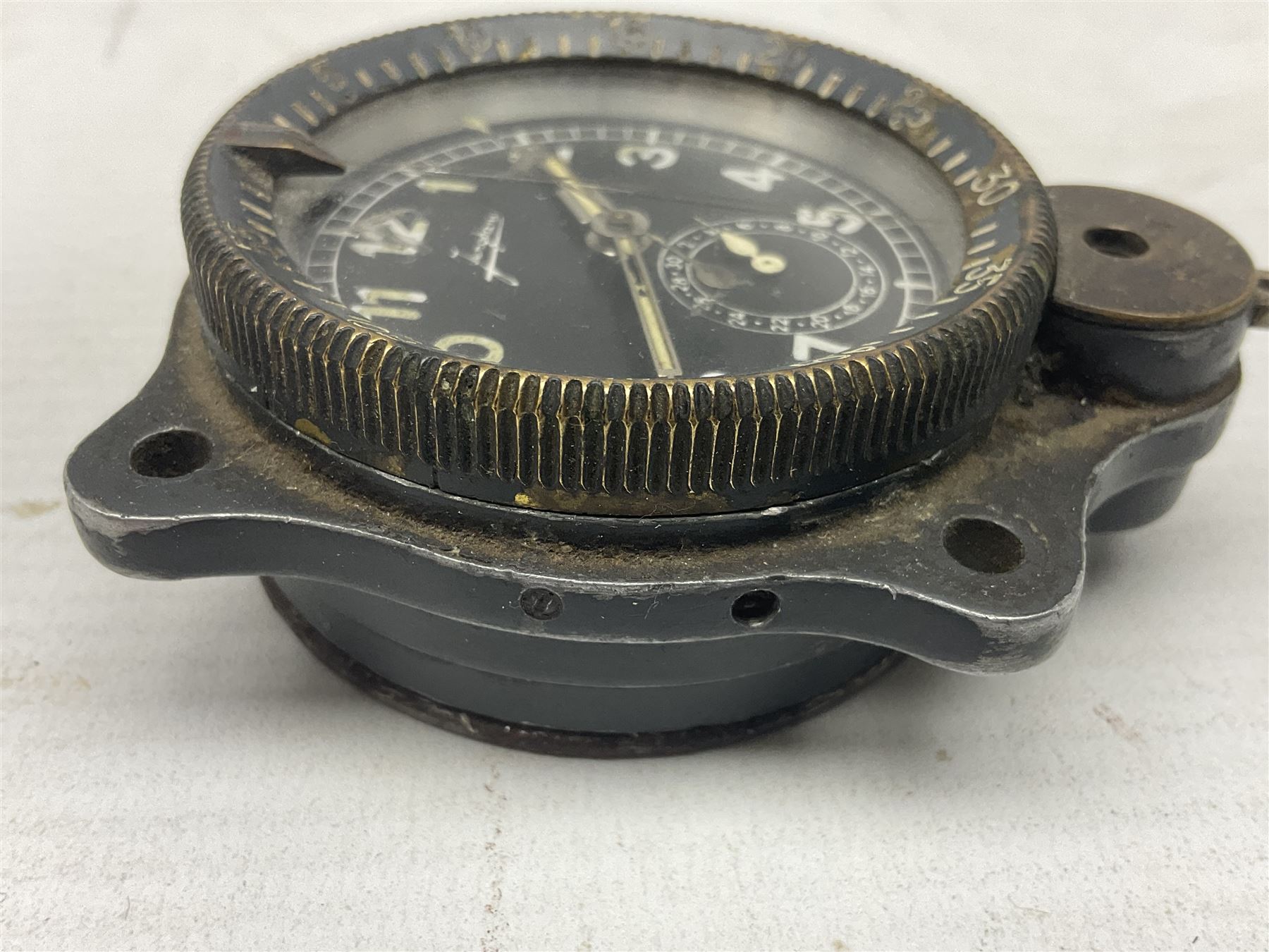 WW2 Jungans Luftwaffe aircraft cockpit clock with luminous centre sweep seconds hand, baton hour and minute hands, regulation 45mm black dial with date recorder, formerly illuminous Arabic numbers and minute track, rotating bezel (seized), going barrel movement with a lever escapement serial No 22901 jewelled to the centre wheel, over-sprung balance with timing  screws, max.H8cm