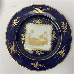 Three Dresden plates, the central panel decorated with a gilt hunting scene, with a bird and floral sprigs border upon a blue ground, with printed mark beneath D22cm 