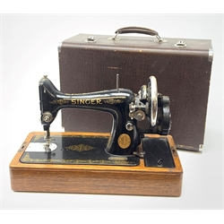 A vintage mid 20th Century cased Singer manual sewing machine, within faux crocodile carry case.