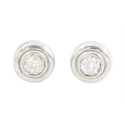 Pair of 9ct white and yellow gold diamond earrings, each stud bezel set with a single old ...