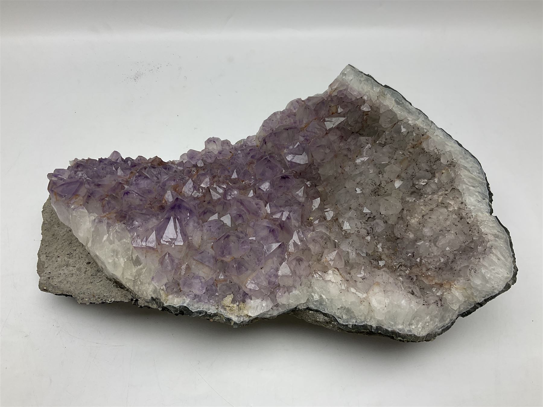 Amethyst crystal geode cluster, with well-defined crystals of various sizes, H13cm, L46cm