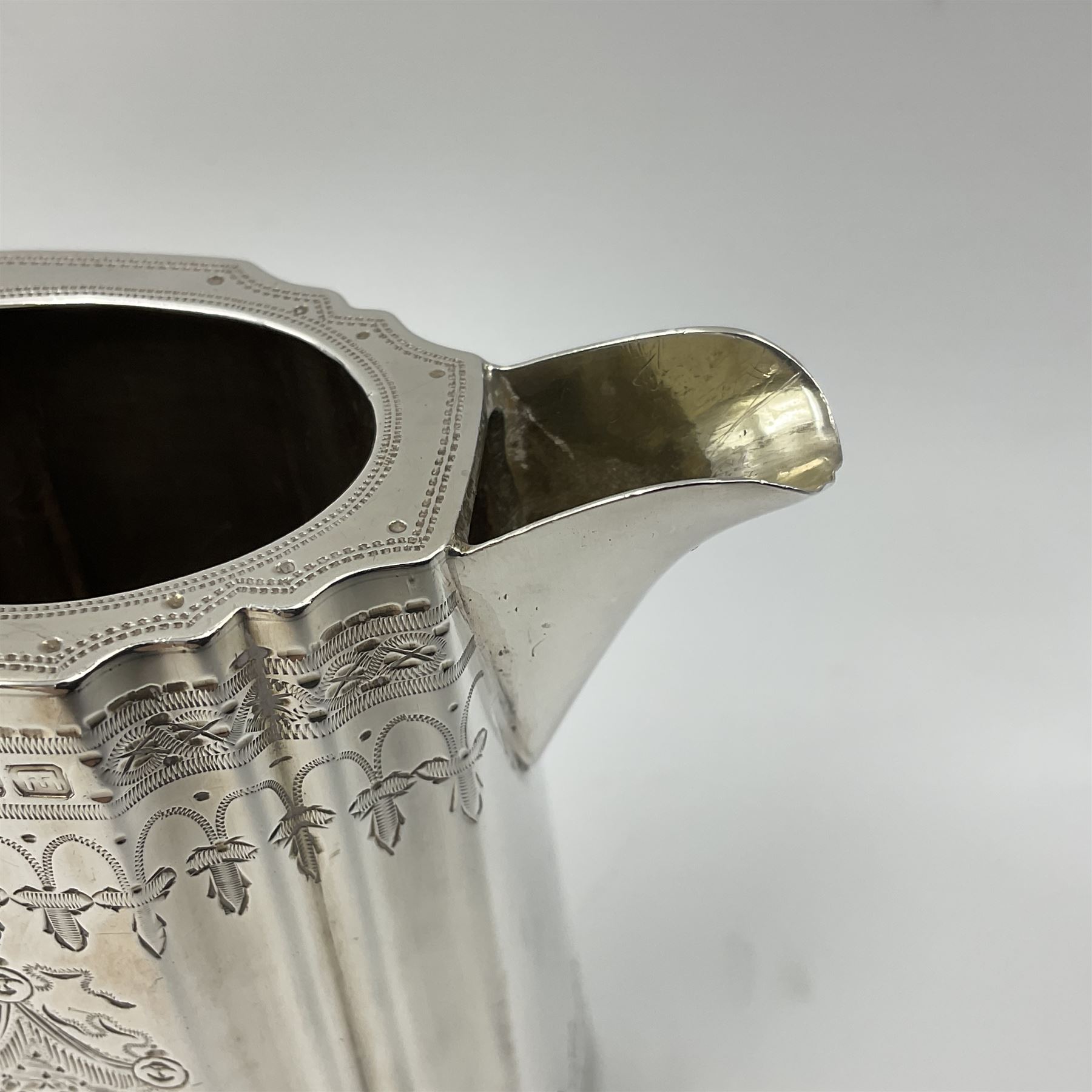 Victorian three-piece silver tea service, comprising teapot, twin handled open sucrier and milk jug, of oval form with shaped rim and C handles, each engraved with crests and bands of strapwork decoration, the milk jug and sucrier with gilt interiors, hallmarked Josiah Williams & Co, Exeter 1881, the teapot with ivory insulators and finial, all contained with a tooled leather, blue silk and velvet lined fitted case, retailed by West & Sun, Dublin 
This item has been registered for sale under Section 10 of the APHA Ivory Act