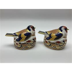 Two Royal Crown Derby Goldfinch Nesting paperweights with silver stoppers, together with two Royal Crown Derby imari pin dishes, largest dish D13cm