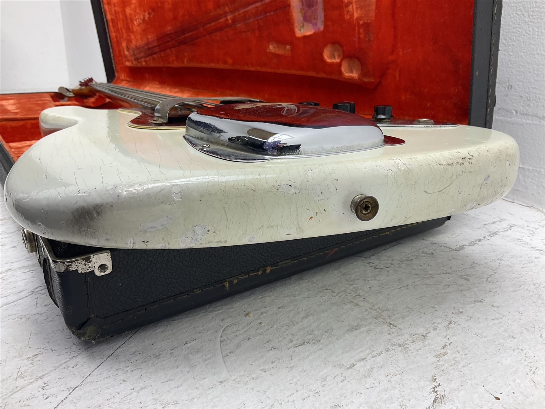 1963 Fender Jazz three-knob bass guitar; impressed with date code 7AUG63A on end of neck and serial no.L08587 on back plate; all original but re-finished in white in the 1970s; sold with photographs of the instrument in the 1960s with original finish and in the 1970s re-finished; L117.5cm; in original hard carrying case; Provenance: the professional guitar of Howard Livett from new to his death in 2005. Howard played in The Humperdincks, the backing group for Englebert Humperdinck, also played in the backing group for Max Bygraves and in the band Hedgehoppers Anonymous. The guitar is also sold with a manuscript letter of provenance from Howard's wife.