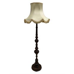 20th century walnut standard lamp, turned column on circular base, with shade 
