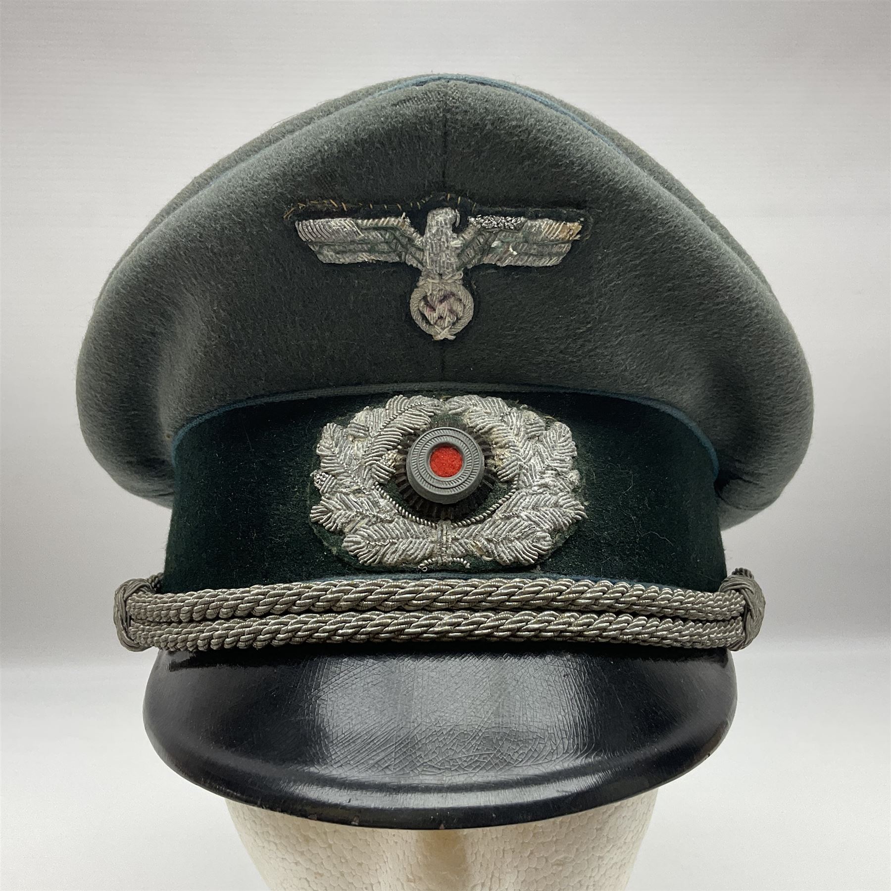 WW2 German Infantry Officer's visor cap with cloth insignia; labelled and stamped Offizier Kleiderkasse Berlin and Erel Stirnschutz