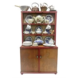 Miniature pitch pine Welsh dresser with open plate rack over two cupboard doors, displayed with Ridgways Humphrey's Clock pattern and other doll's blue/white tea ware, copper kettles and pan etc W41cm H72cm