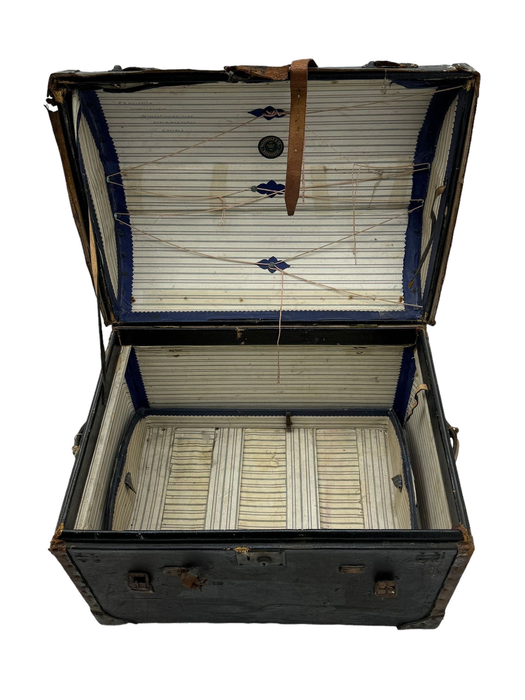 Early 20th century travel trunk, domed top with leather straps and metal rivet detailing, wooden frame with black canvas covering, interior lined with striped fabric, manufacturers mark to the inside 