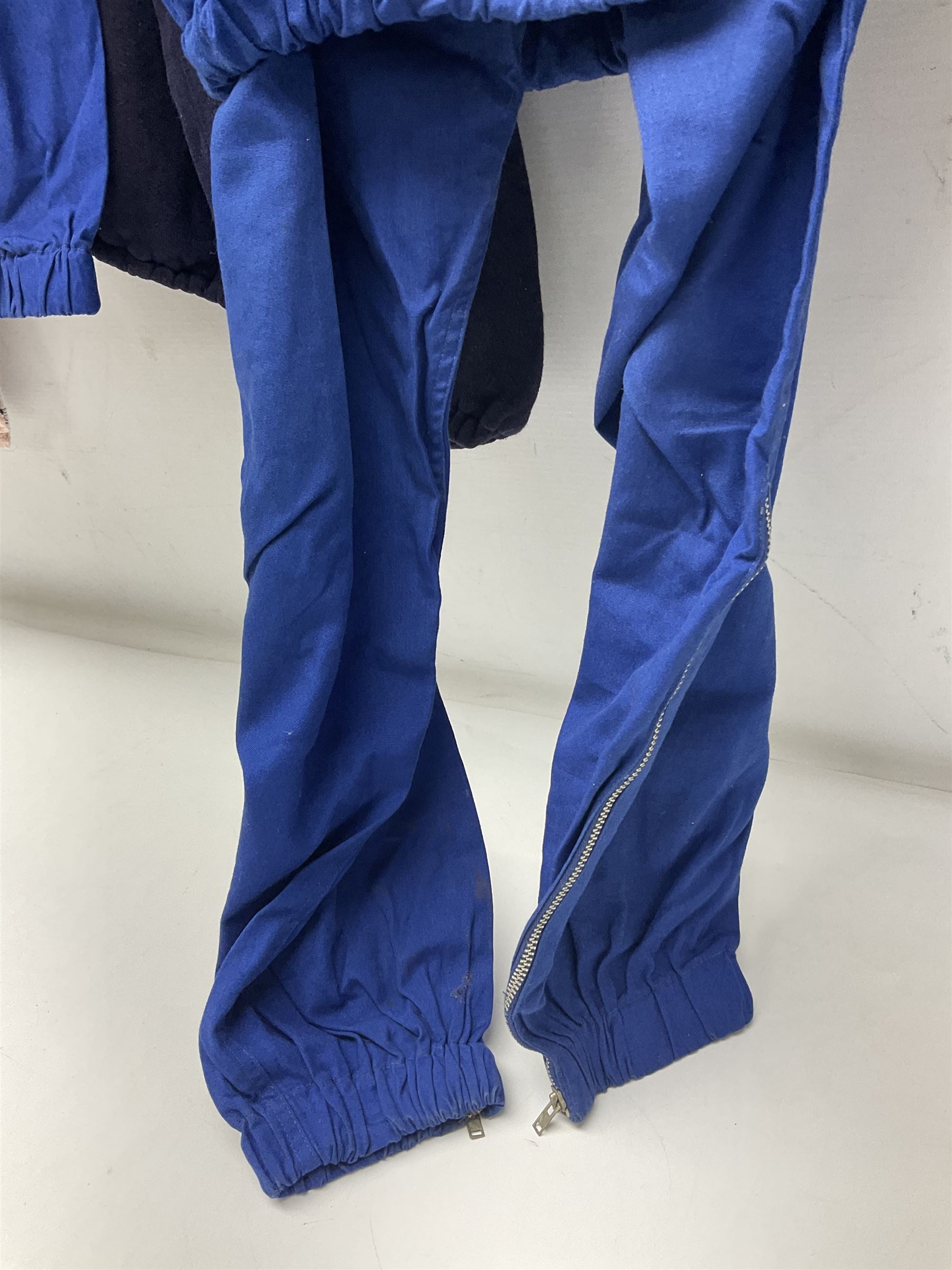 On the direct instructions of Anita Porter nee Lonsbrough Great British Olympic and Commonwealth Games gold medal winning swimmer - collection of early and international memorabilia comprising original Huddersfield Bath Club track suit top bearing eight stitched on cloth badges including British Empire & Commonwealth Games 1958 England Team, YSASA, North Eastern Counties ASA, ESSA Division 3,  English Schools Swimming Association winner etc
The swimming costume Anita wore at the 1958 Commonwealth Games in Cardiff, her first major championships, where she won two gold medals. The grey elastic on the sides, in those days, she would use to make it tighter and more streamlined.
Blue track suit from the 1960 Olympics which she wore on the podium receiving the gold medal.
1960 pool side towelling robe used at the Rome Olympics (interesting to note her name is spelt wrong on the embroidered label).
1962 Commonwealth Games pool side towelling robe used in Perth Australia when winning three Gold medals. 
It was also this year she became BBC Sports Personality of the year, the first female to do so.
Her 'lucky' pool side towel which she took with her to every event she competed in and which can be seen round her neck in many official celebratory photographs. Copies of some of these photographs are included for identification.
In addition there are two souvenir programmes of an evening event to honour Anita at The Theatre Royal Huddersfield and she has kindly signed the front cover on one of these.