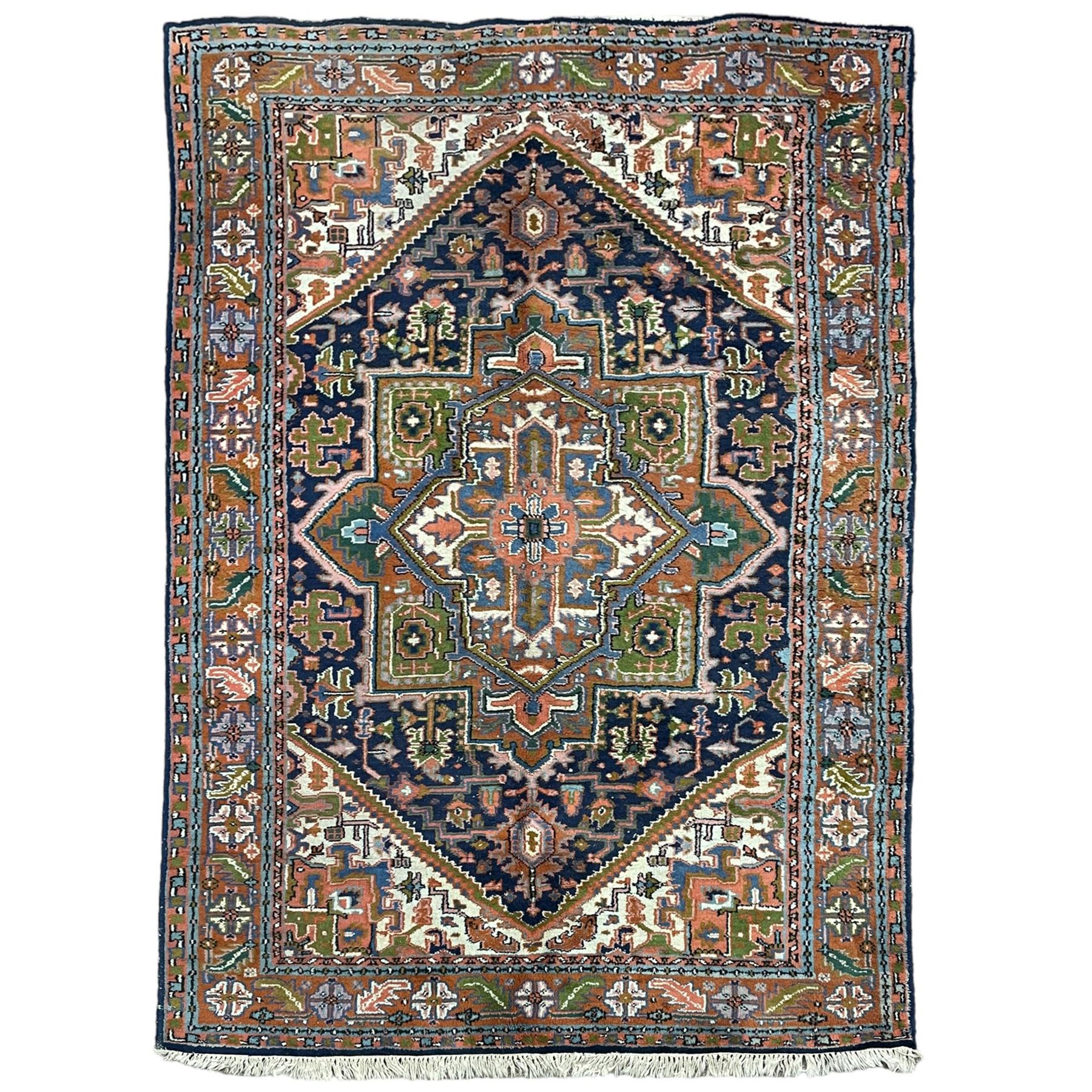 Persian Heriz indigo and rust ground rug, central geometric star medallion decorated with stylised foliate motifs, the border decorated with stylised flower heads