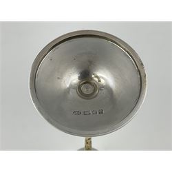 Pair of modern silver candlesticks by Stuart Devlin, the tapering parcel gilt stems with signature textured detailing, each supporting a fluted candle holder and upon a spreading circular foot, hallmarked Stuart Devlin, London 1973, H25cm