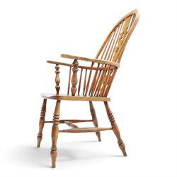 19th century elm Windsor armchair, with central pierced splat, flanked by spindles, dished seat, raised on turned supports united by H-stretcher