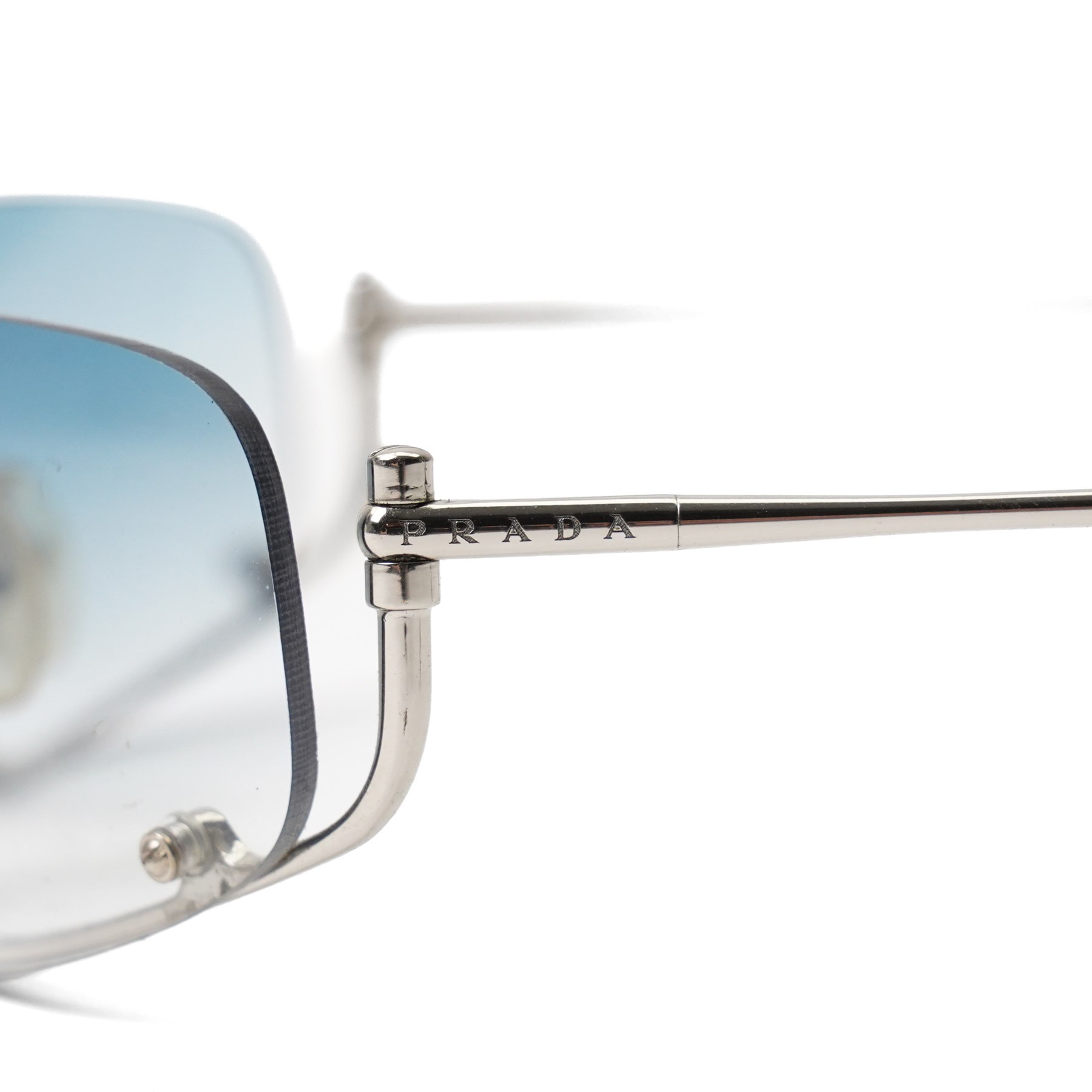 Prada - rimless shield-style sunglasses, with graduated blue smoke lenses, silver-tone metal lower bridge and temples and PRADA lettering to the arms, in original hard case 