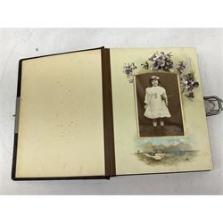 Victorian leather bound photo album, the interior leaves containing apertures of various sizes and shapes of portraits surrounded by printed floral designs, H28cm