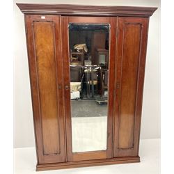 Victorian mahogany triple wardrobe, central mirrored door enclosing linen slides and two short and two long drawers flanked by two cupboards, plinth base