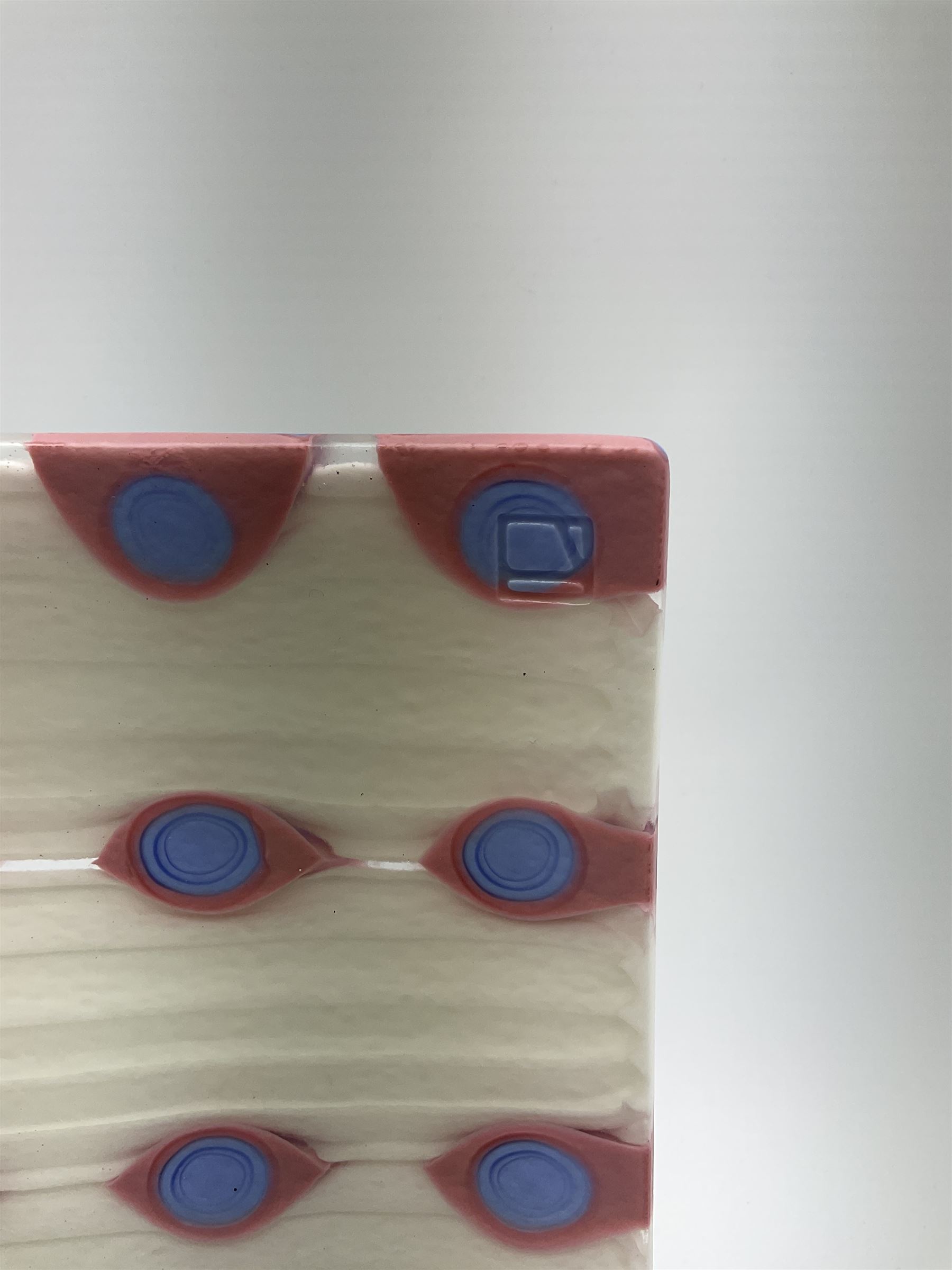 Zdenek Lhotsky glass platter, decorated with geometric motifs in pink and blue upon a white ground, L26cm, with certificate and box.