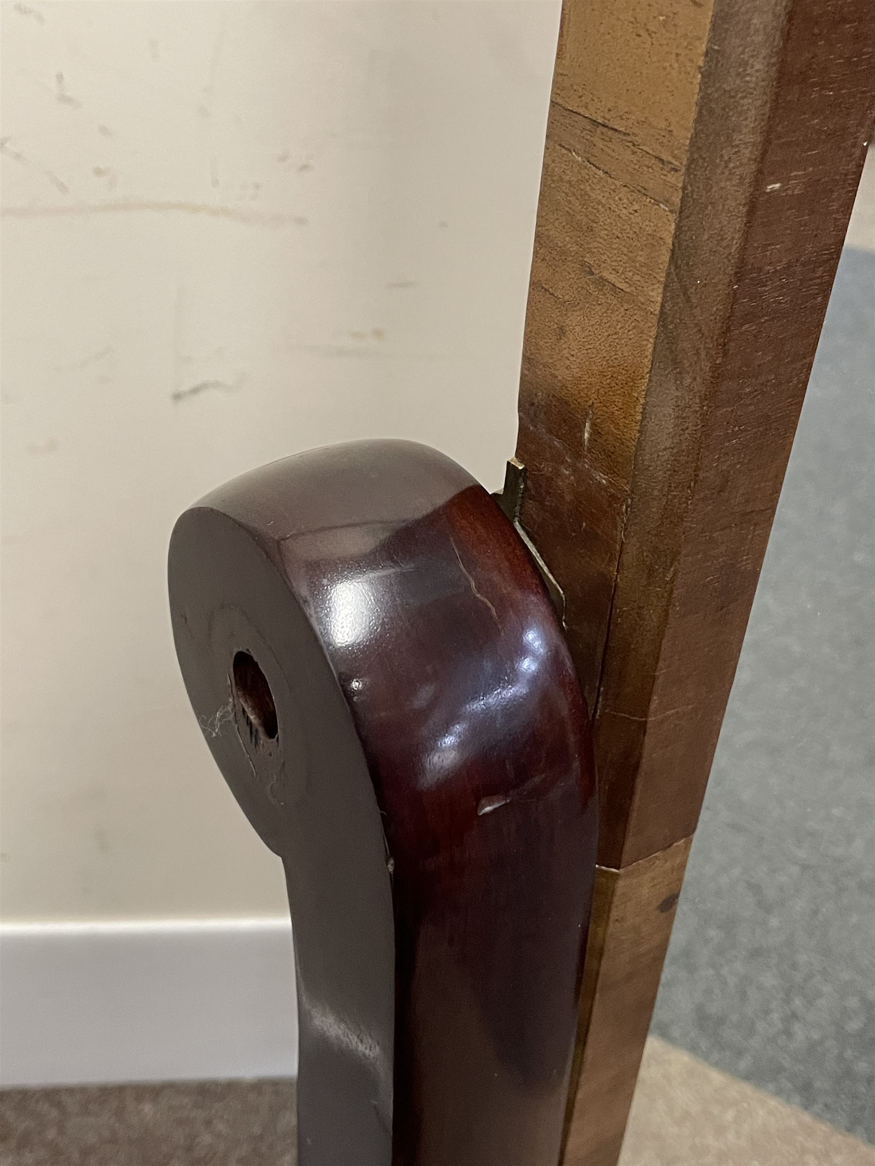 Early 19th century mahogany cheval dressing mirror, plain mirror plate within chamfered frame with arched top, on rolled horns and out-splayed rolled feet, united by turned stretcher 