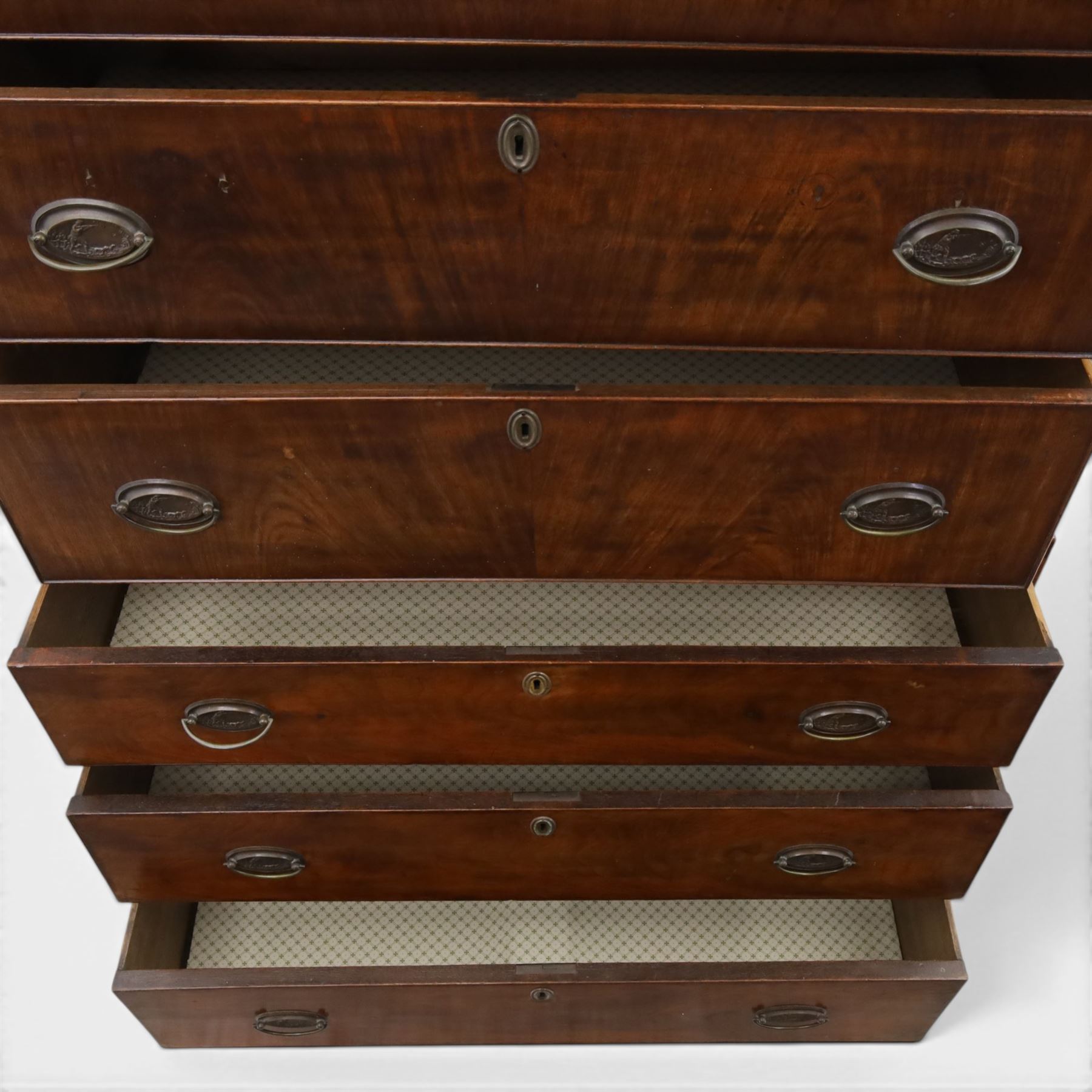 George III mahogany chest on chest, moulded cornice over two short over two long drawers with figured mahogany veneers, lower section fitted with three further long drawers, oval brass plate handles and escutcheons, on shaped bracket feet
