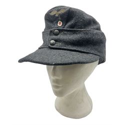 WW2 German Luftwaffe M43 field cap with triangular cloth eagle and roundel badge; marked '1944 ?/0501/0015 57'