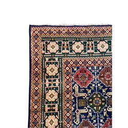 Persian Tabriz indigo ground rug, overall Quba design, decorated with repeating stylised plant motifs and interlaced with trailing leaf motifs, repeating border within geometric guard stripes