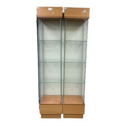 Pair light oak and glass open single display cabinets, glazed back and sides with three shelves, light fitting to top