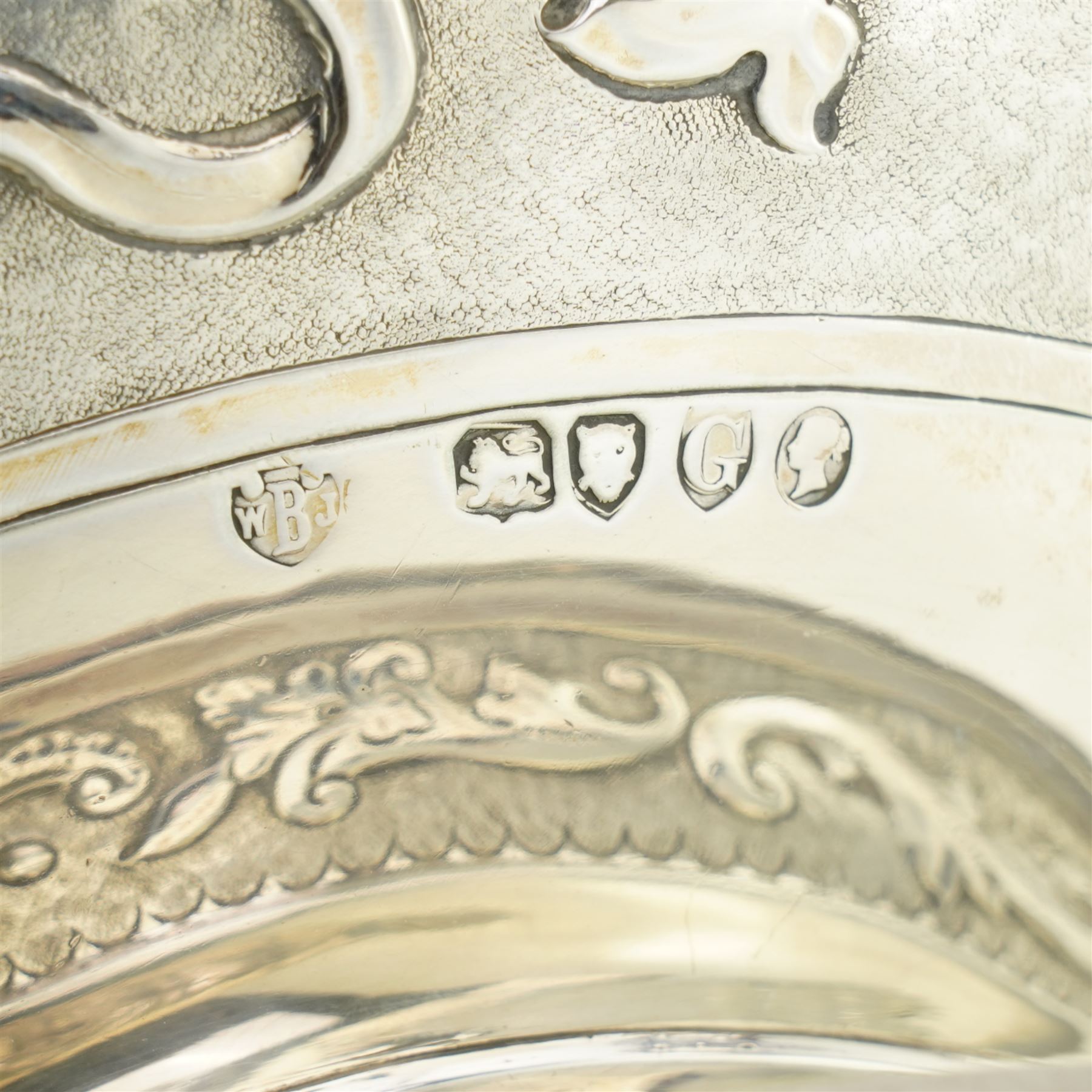 'Delwood Trophy in Memory of Col. H.H. Wilberforce' - A large Victorian silver rose bowl embossed with masks, wings, scrolls etc on a short pedestal foot D29cm London 1882 Maker Walter & John Barnard 