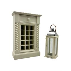 Contemporary painted wooden wine cabinet, rectangular form with carved leaf moulded cornice over single drawer and fifteen bottle compartments, flanked by spiral twist pilasters; together with a cream painted and chrome lantern, with glazed sides and leather handle (2)