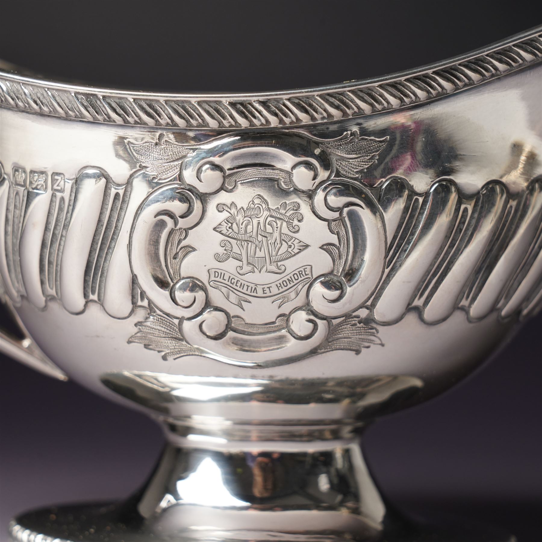 Victorian silver sauce boat engraved with a monogram Sheffield 1892 Maker John Round  & Son Ltd, another with crimped rim Birmingham 1912 Maker Elkington & Co, two silver pepperettes and a small silver challenge cup