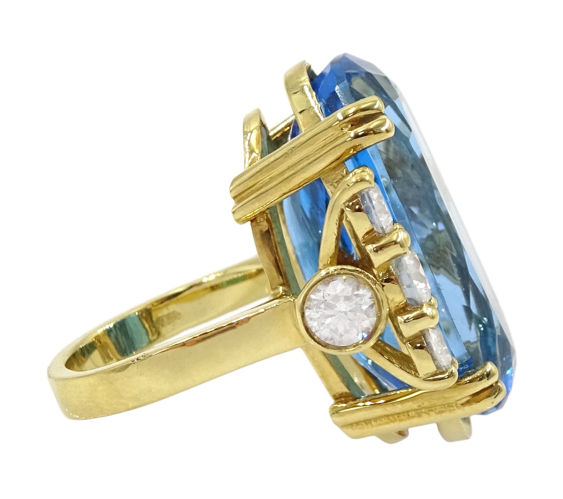 18ct gold blue topaz and diamond ring, single oval cut blue topaz of approx 31.10 carat, with four round brilliant cut diamonds set either side and a further two diamond set to the gallery, London 2019, total diamond weight approx 2.25 carat
