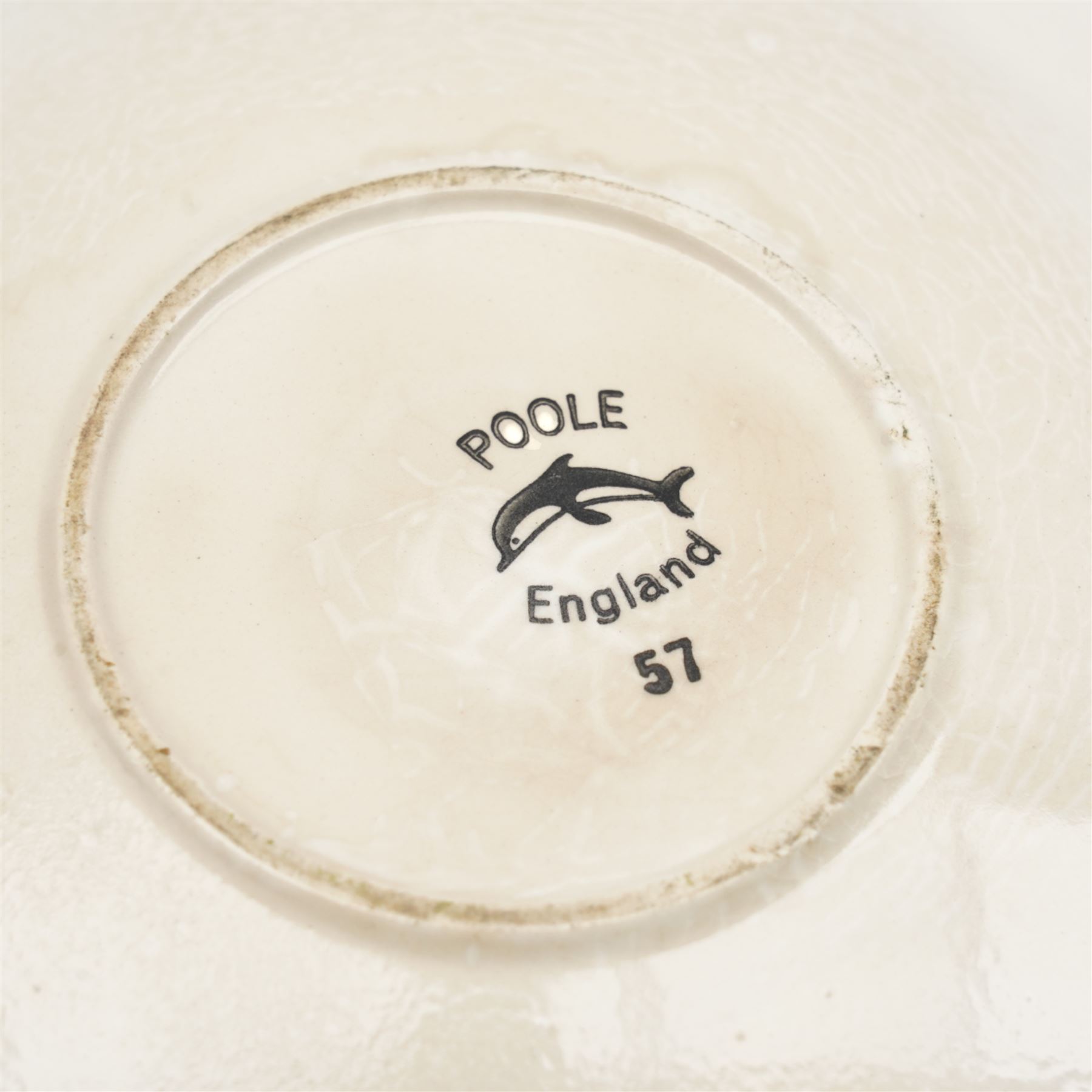 Poole pottery bowl, decorated internally with an abstract black and orange pattern, against a red ground, D27cm, together with a Christina Gray model of a Cheshire cat and an Art Deco vase (3)