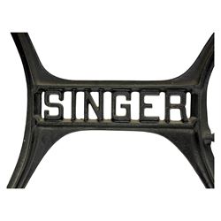 Singer - early 20th century cast iron treadle sewing machine, with hand crank wheel and oak work surface, the machine decorated with gilt foliate detail, complete with rectangular wooden cover and folding extension leaf