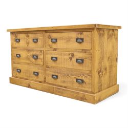 Indigo Furniture - large rustic oak chest, rectangular top fitted with six drawers with metal pull handles, on skirted base