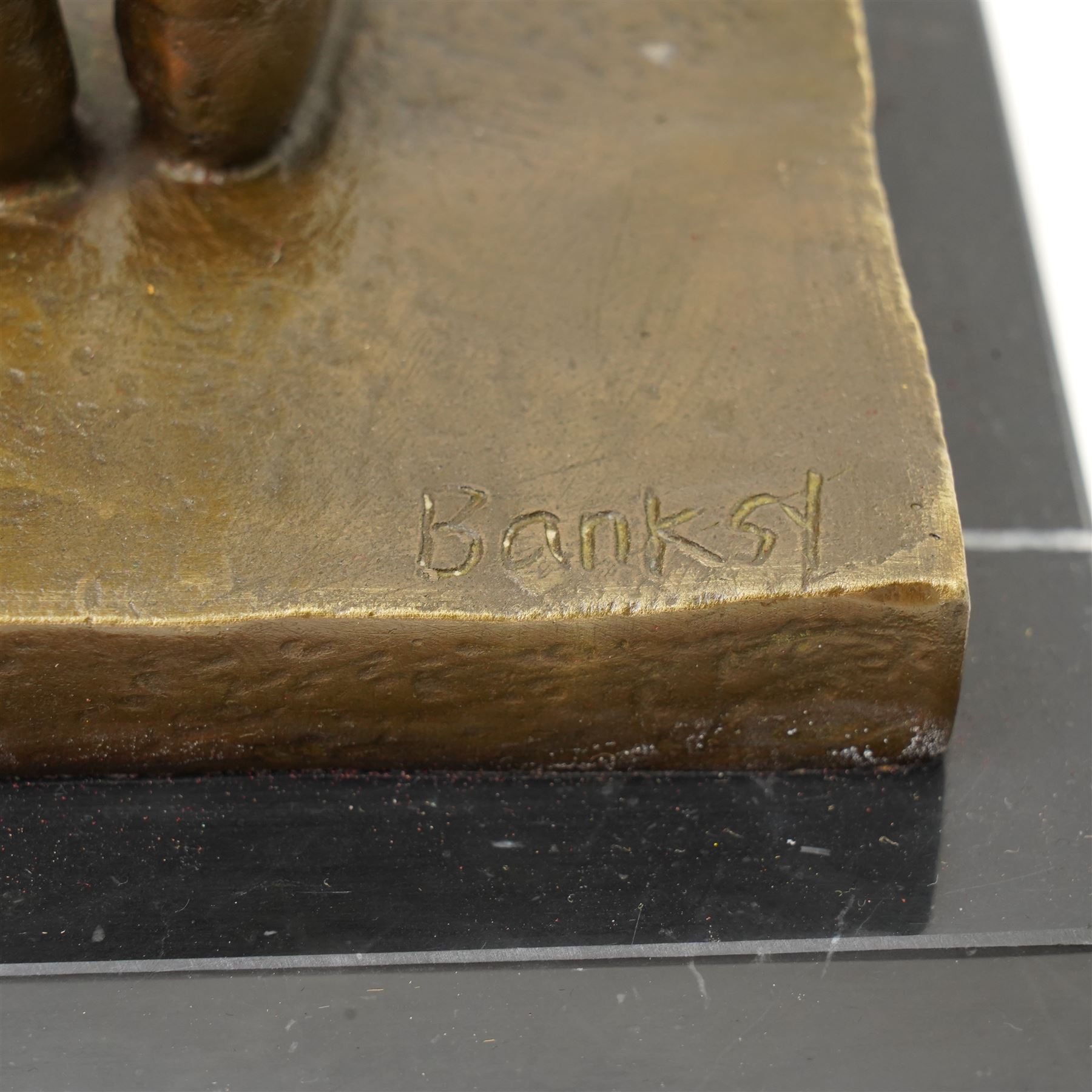 After Banksy - 'Bomb Love', bronze figure of a girl holding bomb, bearing signature, on marble base, overall H32.5cm