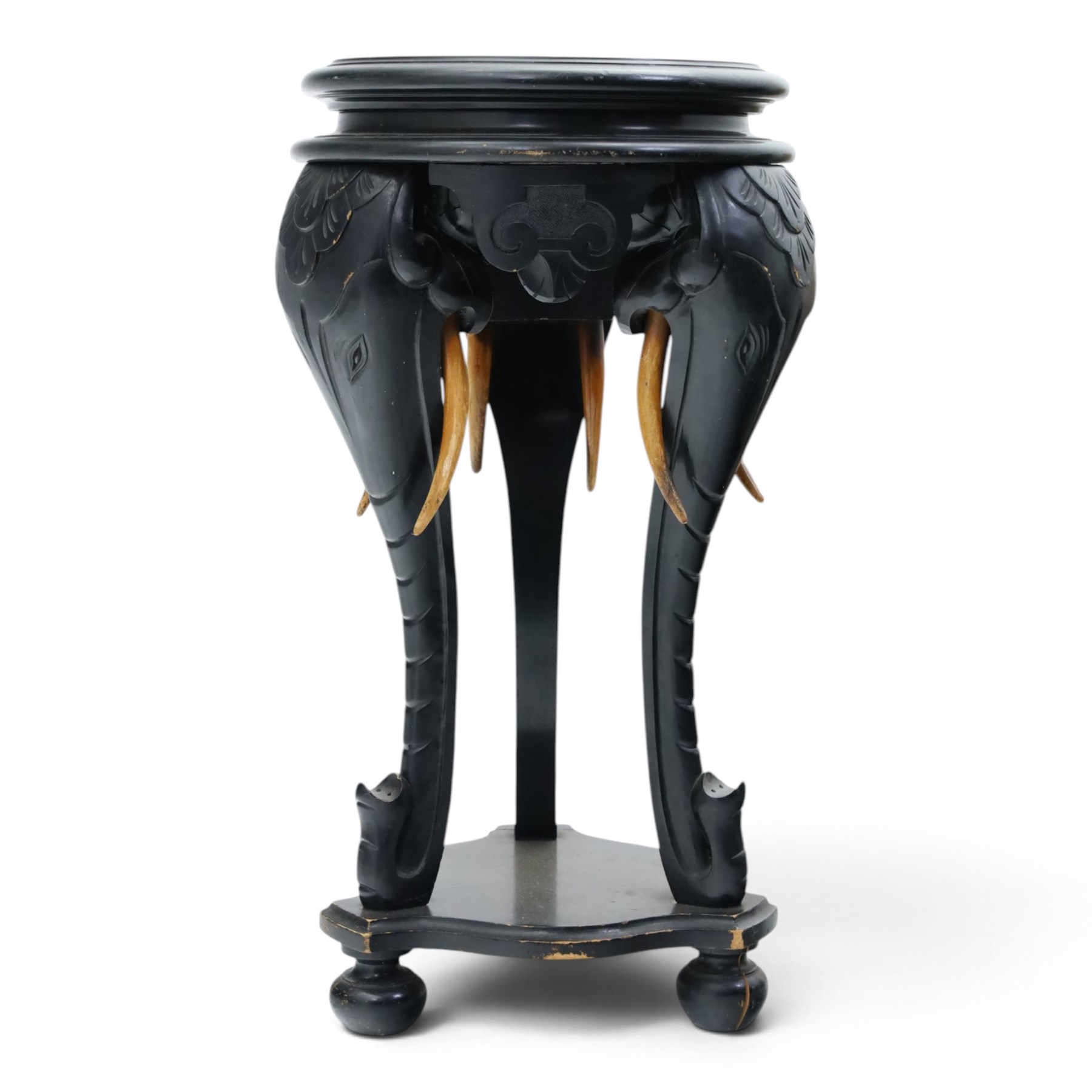 Elephant ebonised jardinière, moulded circular top raised on carved Elephant supports united by a shaped undertier