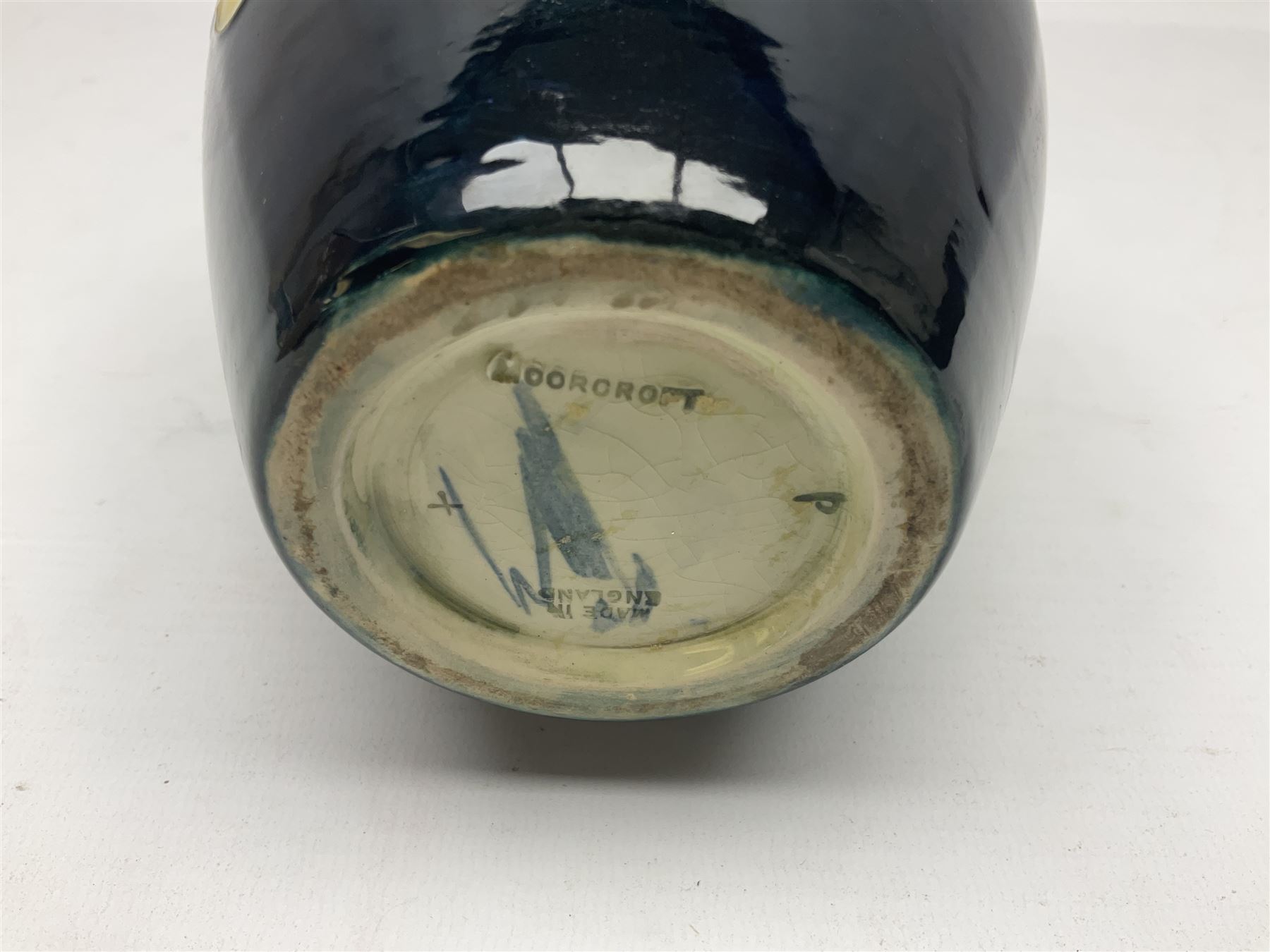 Moorcroft Hibiscus pattern vase of ovoid form, decorated with pink, yellow and purple flowers on merging blue and green vase, with impressed and painted marks beneath, H18cm