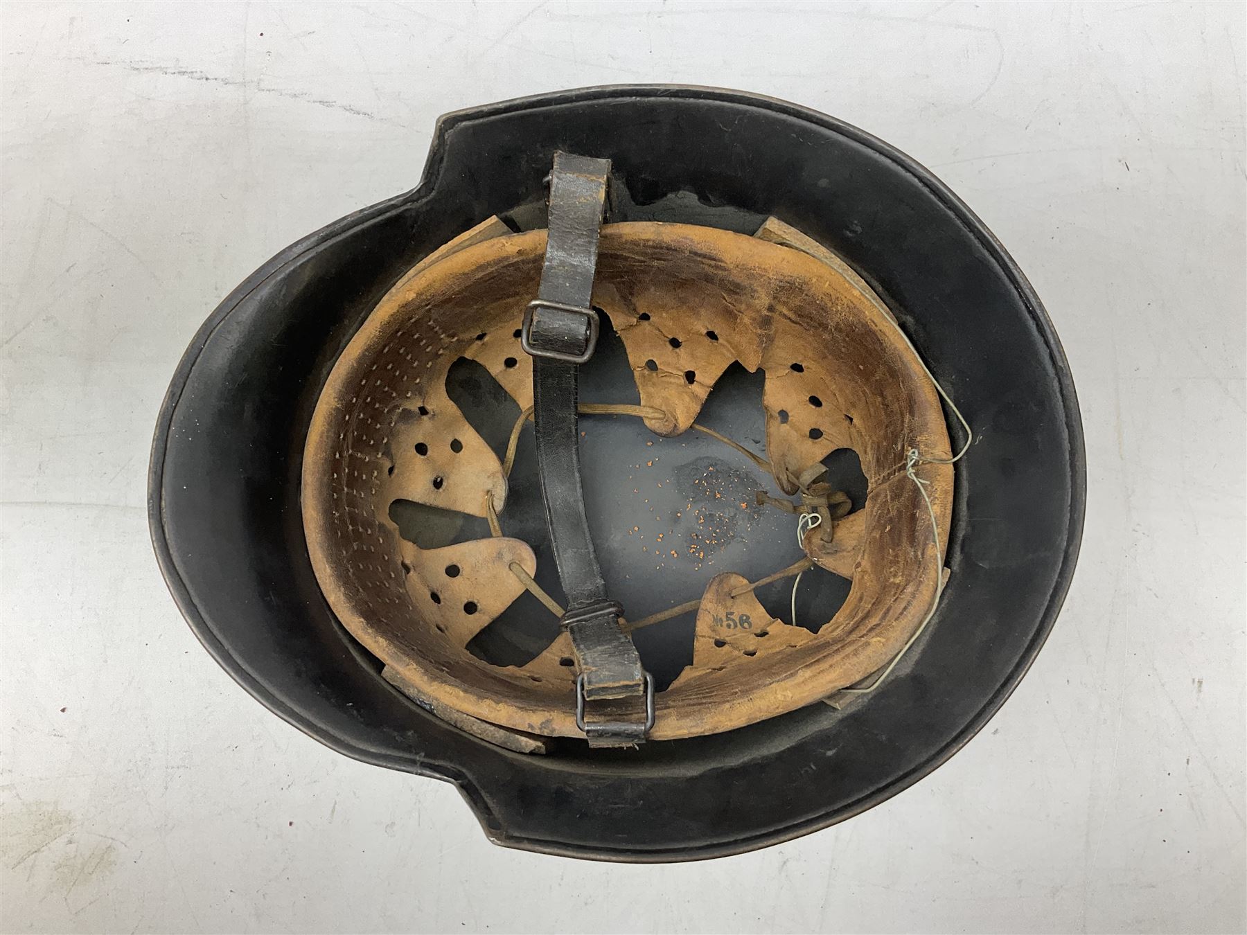 WW2 German steel combat helmet with eagle insignia to one side and U-724 to the other, leather liner marked No.56 and leather chin strap; indistinctly stamped to the skirt '*ahl'