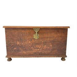 Hong Kong camphor wood chest, rectangular hinged top, carved all over with traditional scenes and dragon boats, on bun feet