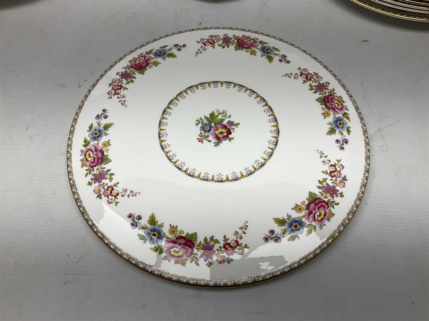 Extensive Royal Grafton Malvern pattern tea and dinner wares, comprising twelve dinner plates, six smaller plates, coffee pot, two teapots, two cake plates, eight teacups and ten saucers, six coffee cups and six saucers, two open sucriers, twin handled lidded sucrier, jug, lidded mustard pot and condiment jar, lidded tureen, two circular twin handled vegetable tureens, sauce boat and stand, oval and circular serving plates, salt and pepper shakers, breakfast cup and two saucers, further large cup and saucer, eighteen tea plates of various shapes, six side plates, six cereal bowls and six further bowls, shell dish and dish of square form, fork and knife, together with a hallmarked silver condiment spoon