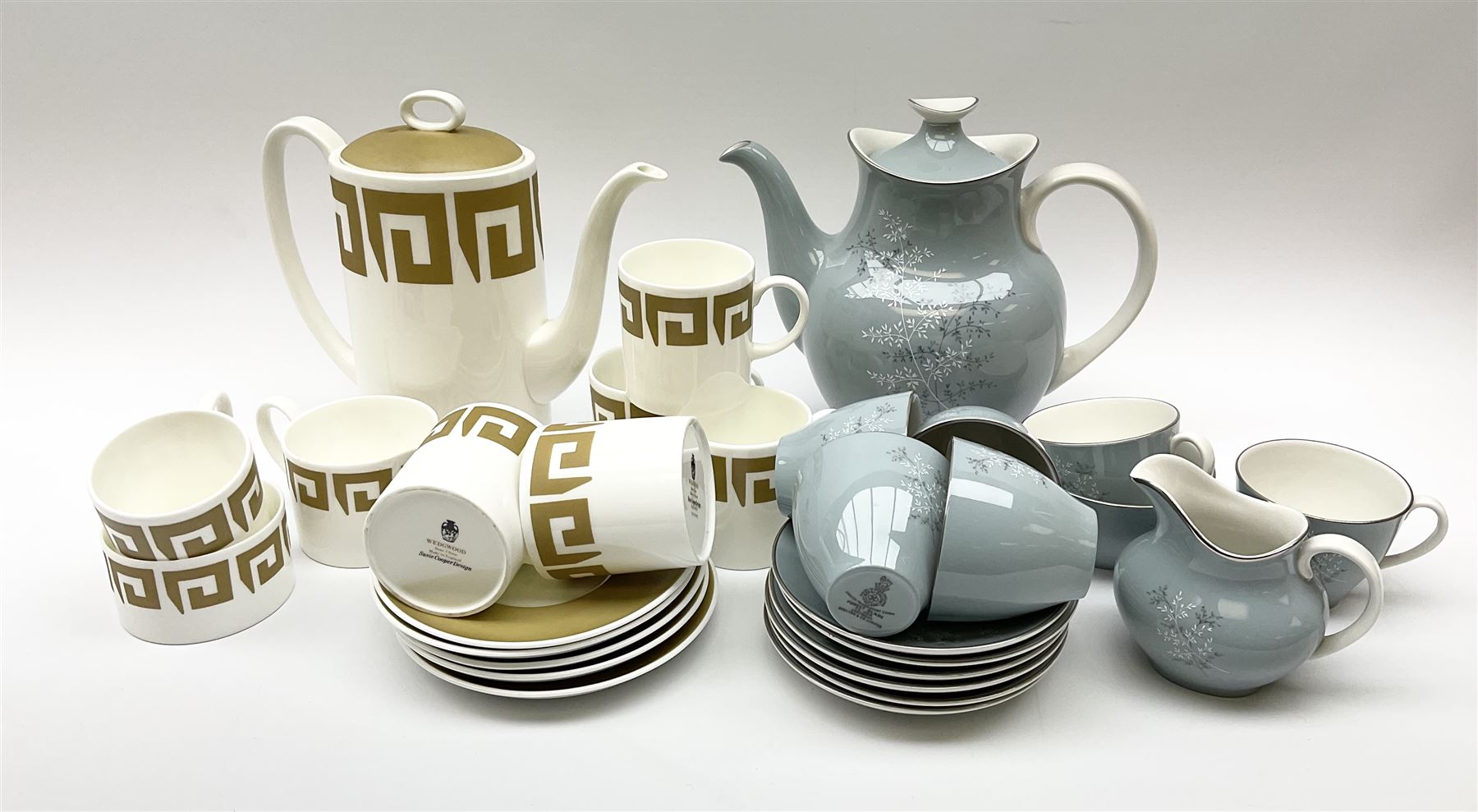 Royal Doulton Forest Glade pattern tea set, comprising teapot, milk jug, open sucrier, six cups and saucers, together with a Wedgwood Susie Cooper tea set, with Greek key decoration, comprising coffee pot, six cups and five saucers, open sucrier and milk jug.