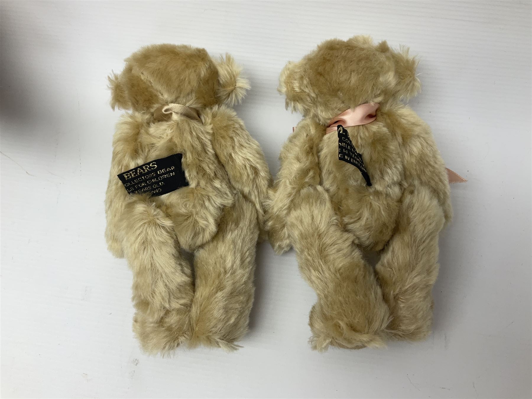 Group of five teddy bears comprising ‘George’ a unique pellet filled bear with glass eyes and velvet paws H38cm, and ‘Abbey’ a luxury German plush with wobble head and glass eyes no.5/10 H24cm, both with Teddies from Bearyland labels; along with two light blonde mohair H. M. Bears and Boyds Bears ‘T. F. Wuzzies’ no. 595140 (5)