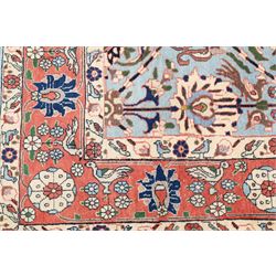 Persian Tabriz cyan ground rug of Benlian design, the field decorated with large palmette motifs, the crimson and ivory guard lines with repeating bird of paradise and interspersed stylised plant motifs