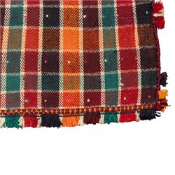 South West Persian Jajim kilim, formed from two joined flatwoven panels, patterned with intersecting stripes in red, orange, green, dark brown and ivory forming a checked design, scattered coloured dot motifs, multicoloured wool tassels along the sides