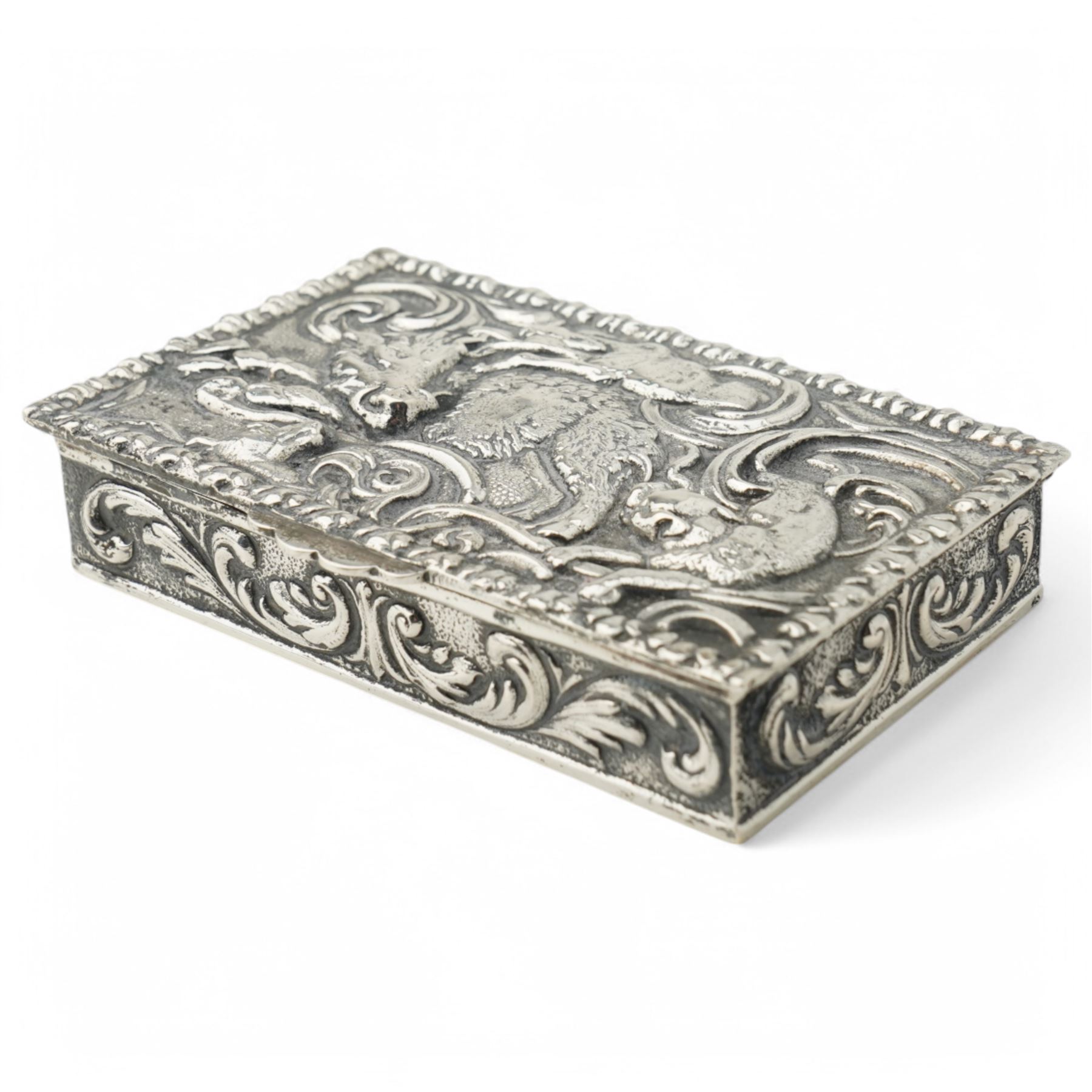 Spanish rectangular silver box, the hinged cover embossed with a hunting scene 9.5cm x 6cm 915 fineness mark and a silver decanter label 'Brandy'