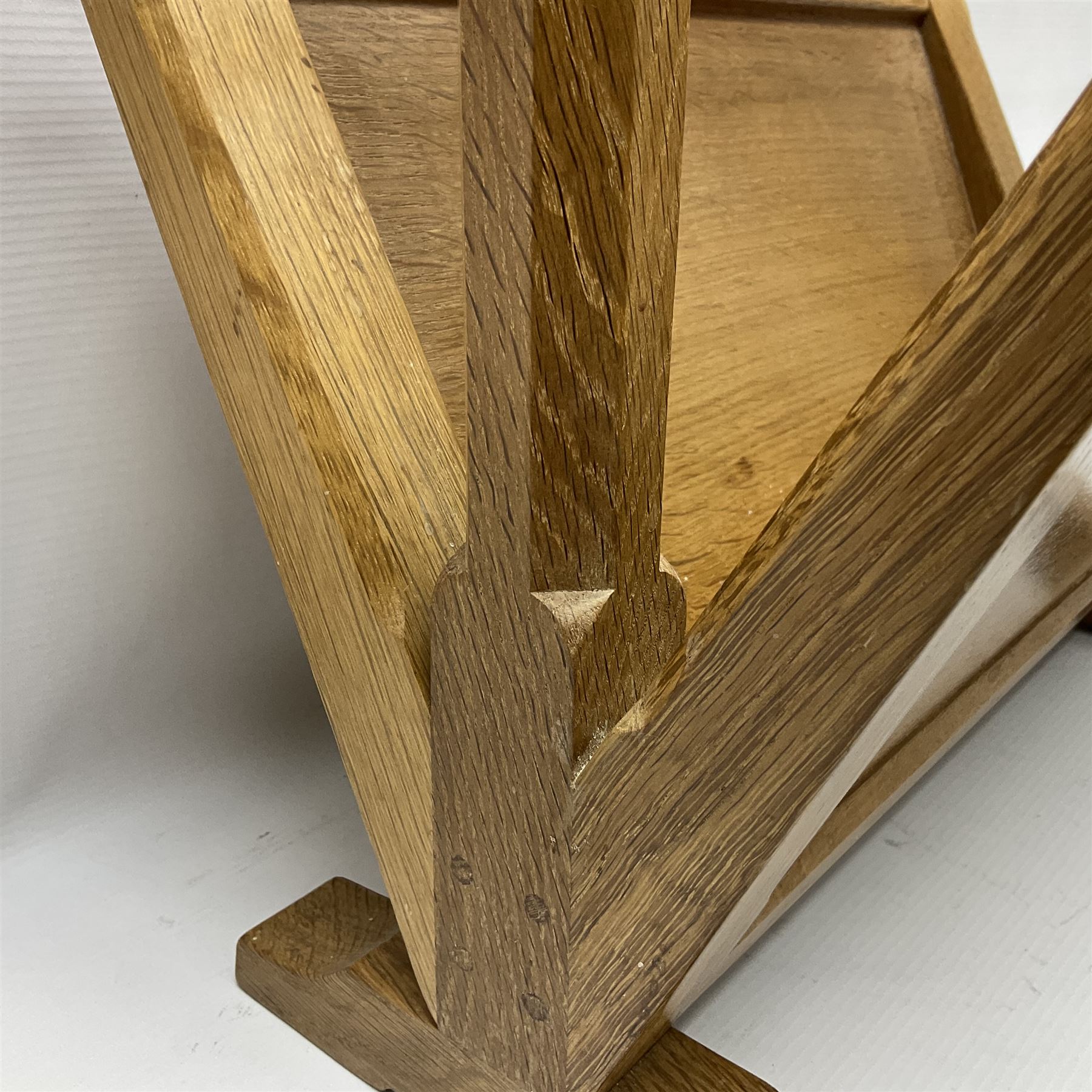 Mouseman - oak magazine rack, the top rail pierced with handle and carved with mouse signature, octagonal supports with two panelled and splayed sides, on sledge feet, by the workshop of Robert Thompson, Kilburn 