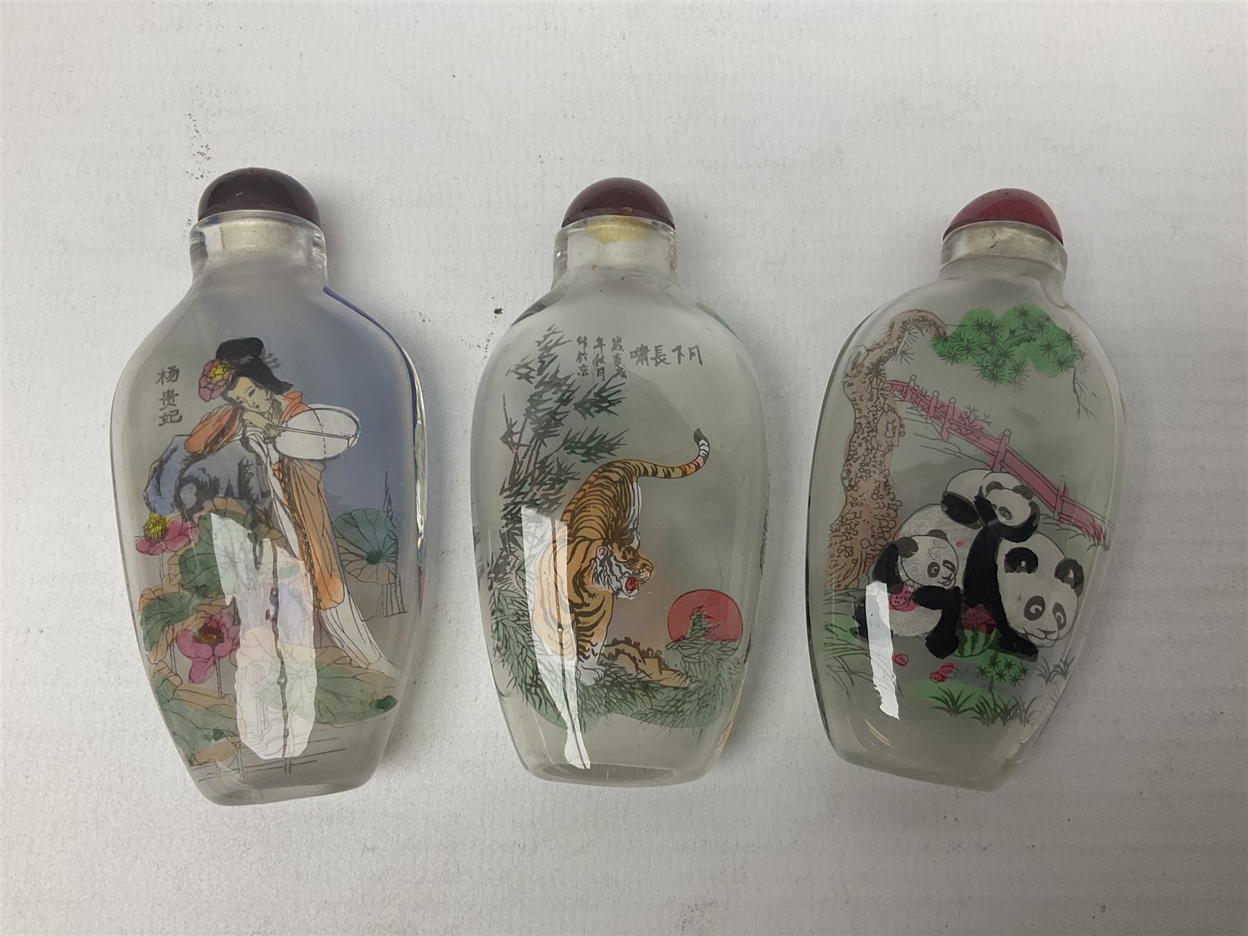 Seven Chinese glass snuff bottles painted with figures and animals, together with three wood mounted bone examples