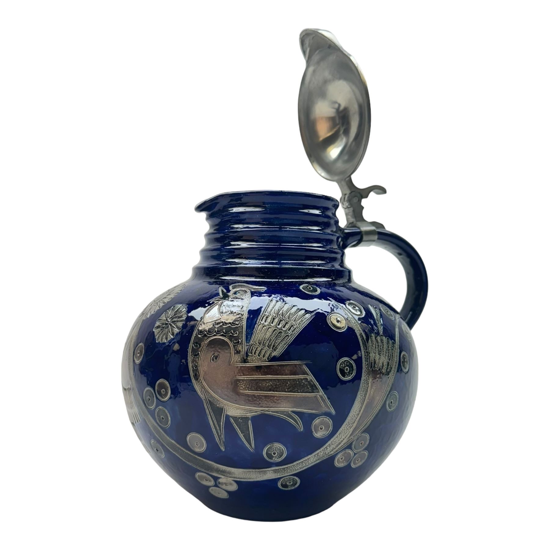 Wim Muhlendyck (1905-1986),  saltglaze stoneware jug of globular form with pulled and applied handle and ribbed neck with white cover, with stylised cockerels and flowers on a dark blue ground, with makers mark beneath, H22cm