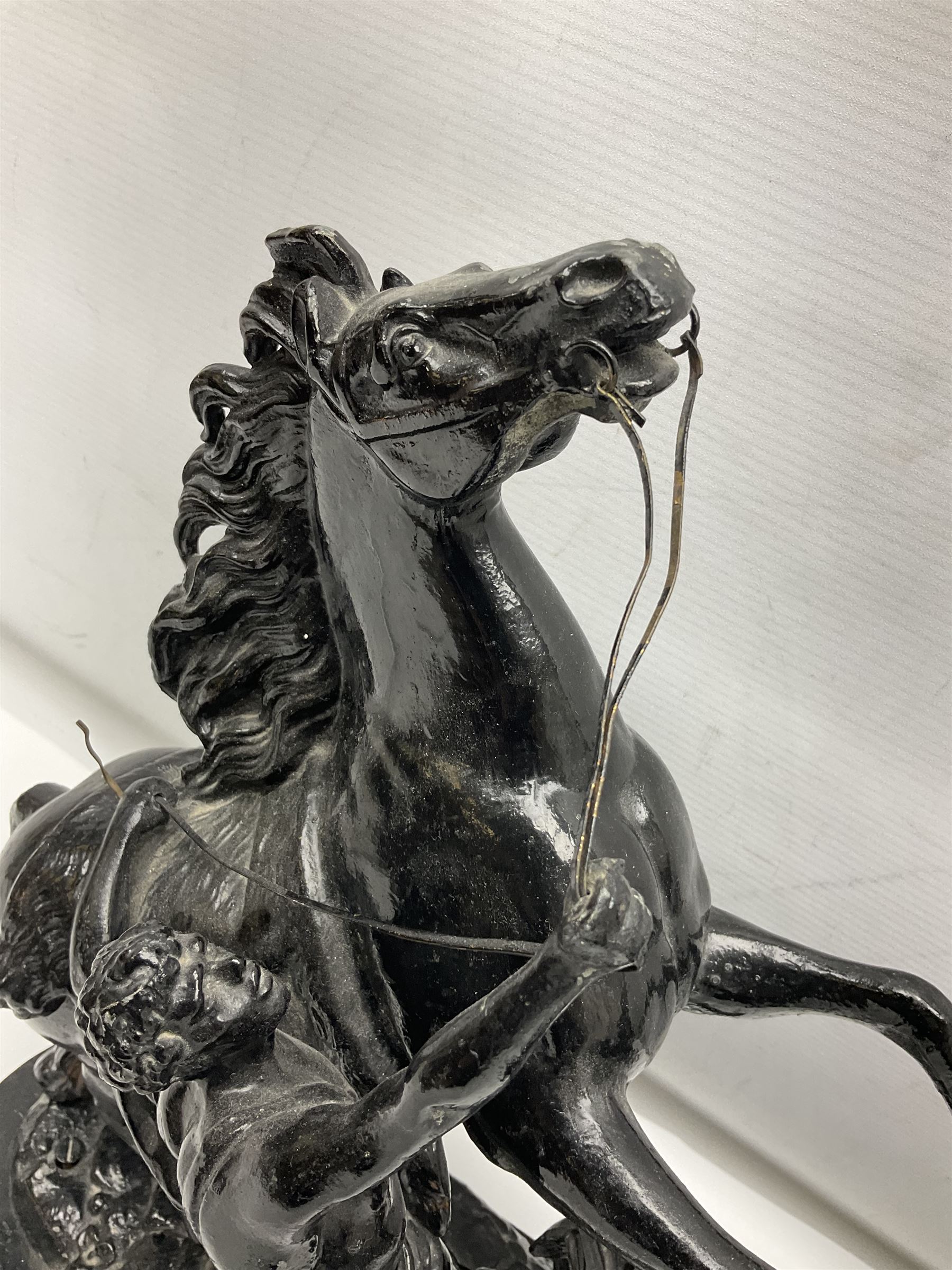 Pair of spelter figural statues of man and rearing horse, height 44cm and 42cm