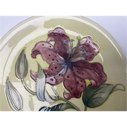 Moorcroft Tiger Lily pattern plate on a yellow ground, with painted and impressed mark beneath, D26cm