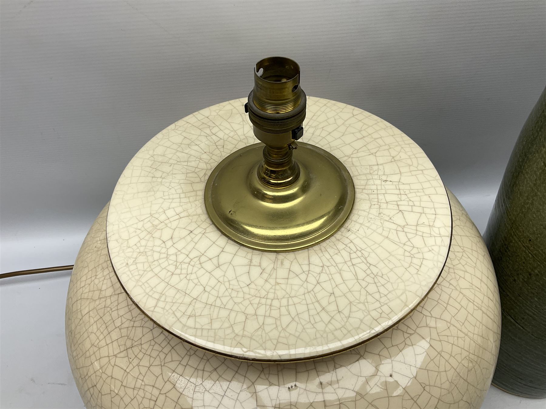Large cream crackle glaze table lamp, together with a tall studio pottery vase in green with single loop handle, with impressed makers mark, H49cm