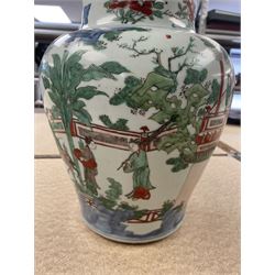 17th century Transitional period Chinese Wucai vase and cover, of baluster form, the body painted with ladies upon a terrace, and figures upon horseback and attendants within a fenced garden, the domed cover with knop finial painted with boys at play, H37cm
